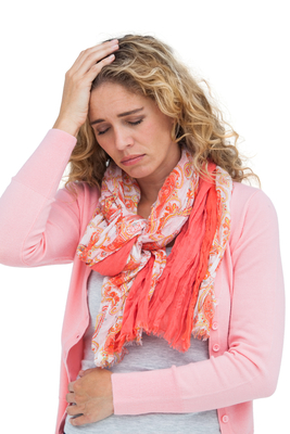 Blonde girl having both headache and belly pain on white background